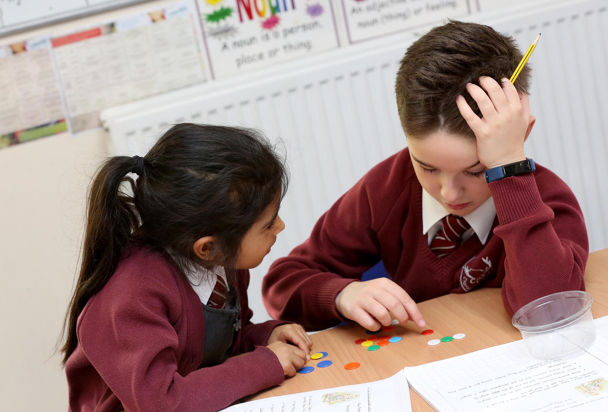 A teacher reading to children in a classroom